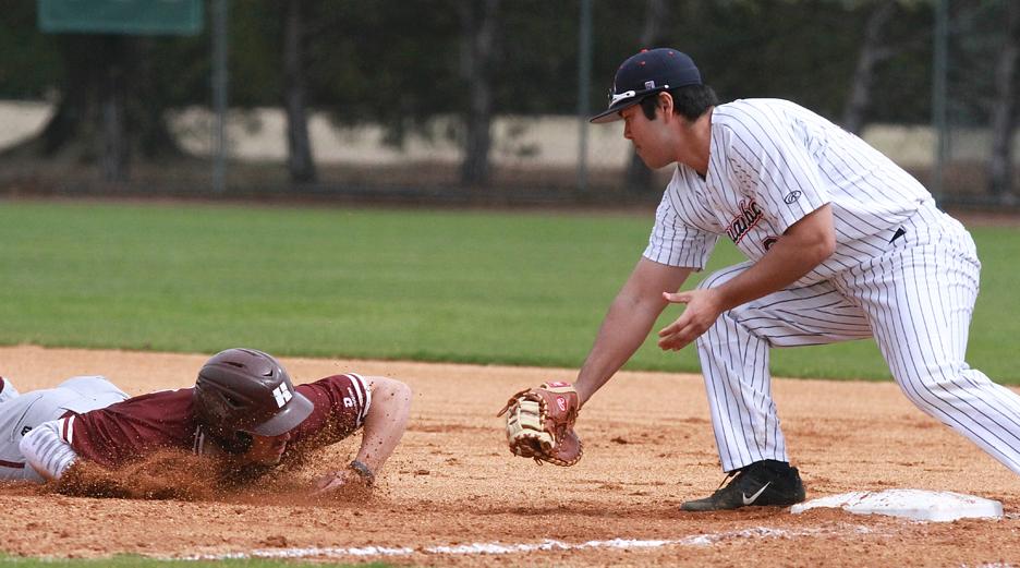 Timothy Rowe( 24) waits to tag a Holmes base runner during a pick off attempt. (ICCImages.com)