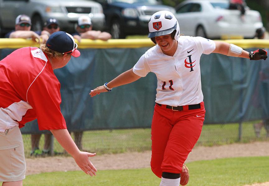 Autumn Bonner celebrates with Coach London Ladner after hitting a grand slam in the seventh-inning. (ICCImages.com)