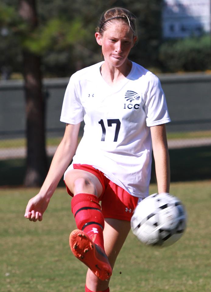 Karlee Grisham kicks a pass attempt away from a defender in a game earlier this season. (Lee Adams/ICCImages.com)